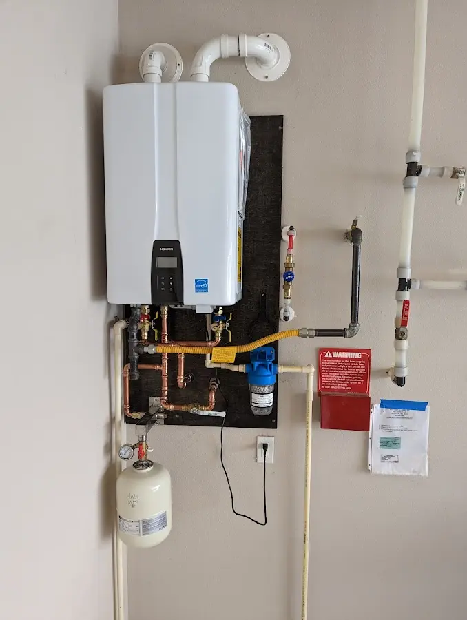 Professional plumber installing copper piping in a Hampstead home